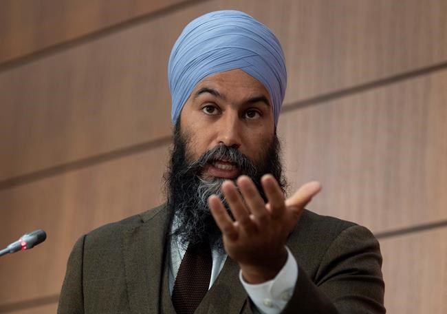 NDP leader Jagmeet Singh gestures during a news conference Tuesday June 9, 2020 in Ottawa.  Singh says it is irresponsible and wrong-headed for the Liberal government to draft a bill that would fine or imprison people who made fraudulent claims under the Canada Emergency Response Benefit. THE CANADIAN PRESS/Adrian Wyld