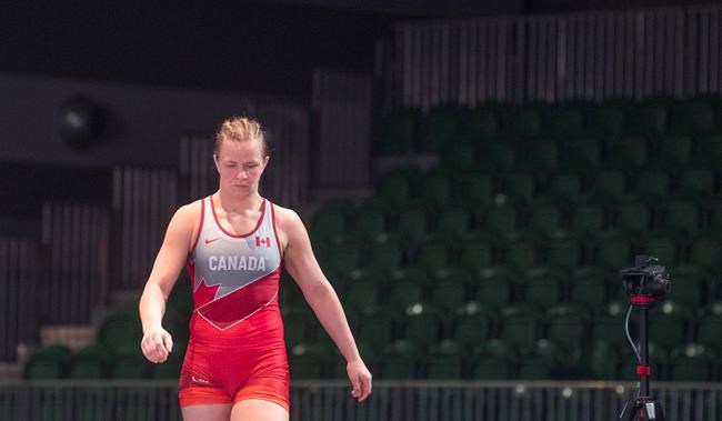 Empty seats provide the background as Canadian wrestler Erica Wiebe steps on to the wrestling mat for competition at the Pan-American qualifier Saturday, March 14, 2020 in Ottawa. THE CANADIAN PRESS/Adrian Wyld