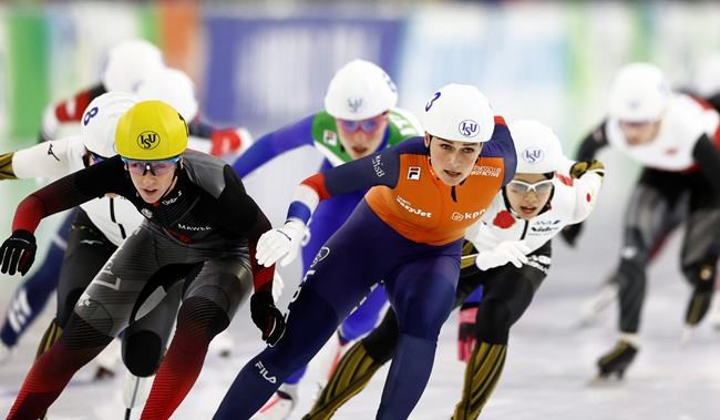 Canada's Ivanie Blondin, left, and Irene Schouten, center, sprint towards the finish line of the women's mass start race in the final of the World Cup speedskating at the Thialf ice arena in Heerenveen, northern Netherlands, Sunday, March 8, 2020. (AP Photo/Peter Dejong)