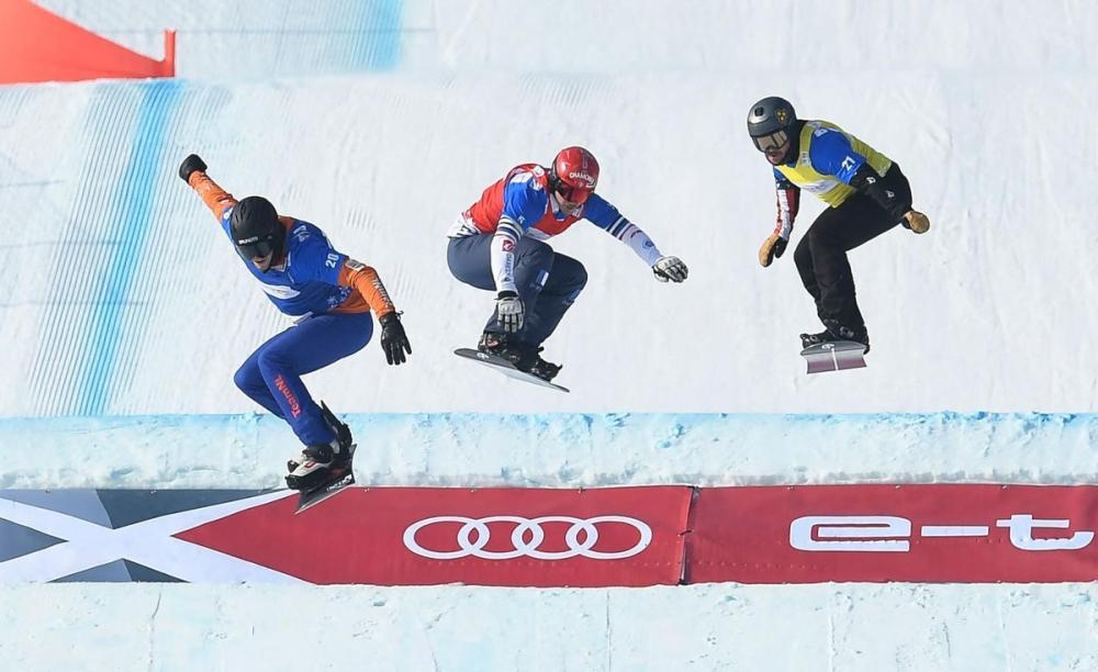 WANG ZHAO - GETTY IMAGES
Mick Dierdorff, Glenn Blois De and Merlin Surget compete in a snowboard test event on the Beijing Olympics course. The Winter Olympics are less than a month away.