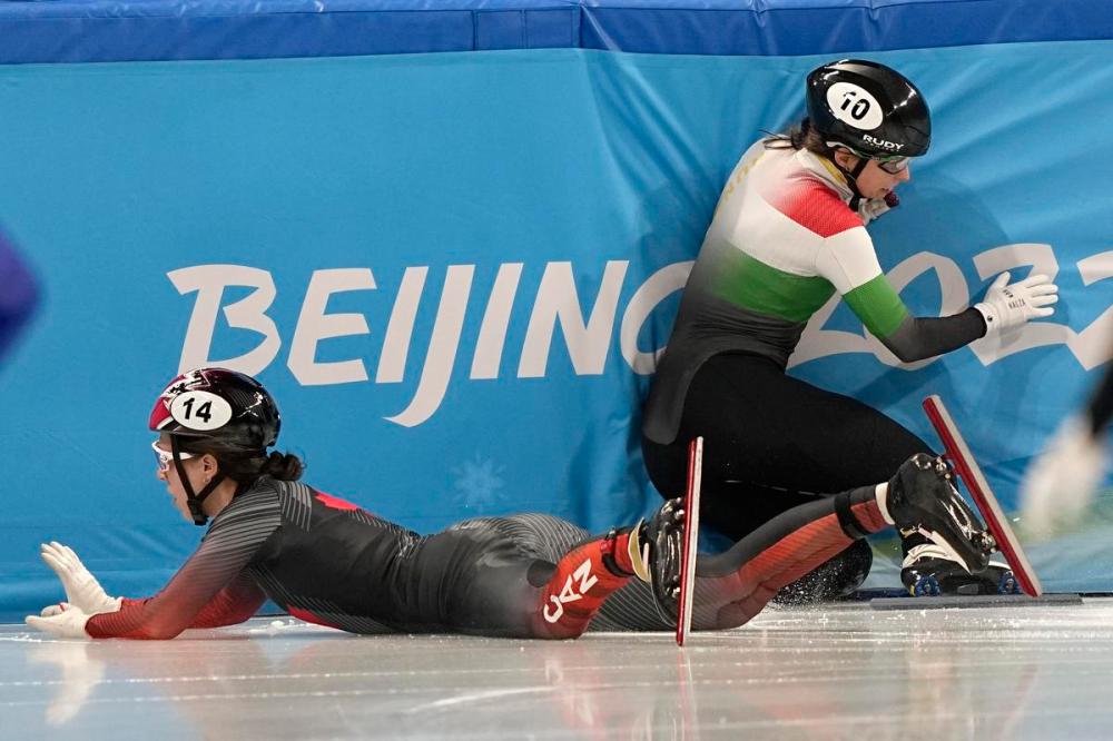 David J. Phillip - AP
Florence Brunelle, left, of Canada, and Petra Jaszapati of Hungary crash in the mixed team relay final during the short-track speedskating competition at the 2022 Winter Olympics, Saturday, Feb. 5, 2022, in Beijing.