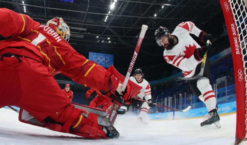 BRUCE BENNETT - POOL/AFP via GETTY IMAGES
Canada's Eric O'Dell, right, scores on Team China goaltender Paris O'Brien during their men's preliminary round group match at the Beijing Olympics.