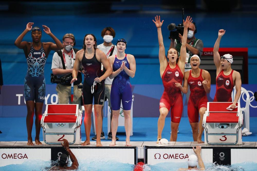 Tom Pennington - GETTY IMAGES
Members of U.S. and Canadian women’s 4x100 swim relay teams react during Sunday’s final in Tokyo. Canada finished with a silver medal.