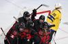 ANTHONY WALLACE - AFP via GETTY IMAGES
Canada's Erin Ambrose celebrates with teammates after scoring the team’s sixth goal past Sweden's goaltender Emma Soderberg during their women's hockey quarterfinal match at the Beijing 2022 Winter Olympic Games.