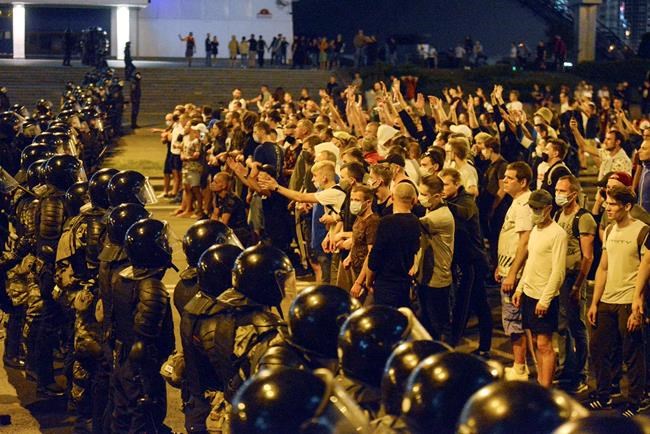 People argue with police during a rally after the Belarusian presidential election in Minsk, Belarus, late Sunday, Aug. 9, 2020. Police and protesters clashed in Belarus' capital and the major city of Brest on Sunday after the presidential election in which the authoritarian leader who has ruled for a quarter-century sought a sixth term in office. (AP Photo)