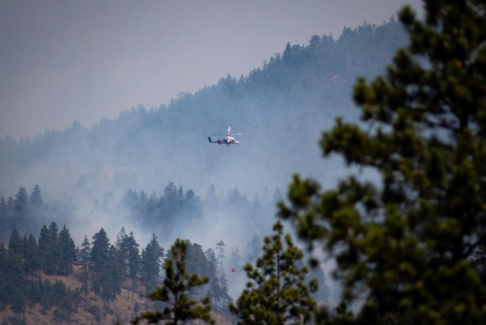 DARRYL DYCK - THE CANADIAN PRESS file photo
A helicopter pilot prepares to drop water on a wildfire burning in Lytton, B.C., in July. In the west, extreme heat has once again sparked sweeping forest fires, while northwestern Ontario, including Red Lake and Kenora Regions, has battled intense blazes as well.