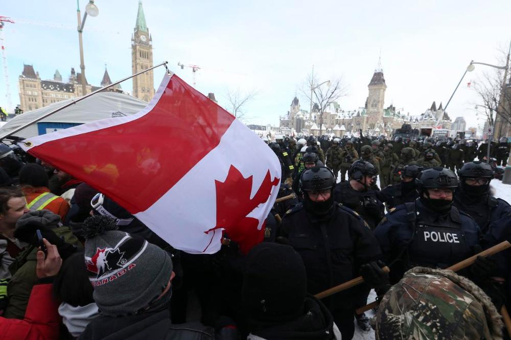 Steve Russell - Toronto Star
Police clear protesters from the area surrounding Parliament Hill on Feb. 19, 2022. Tens of thousands of workers in sectors from retail to restaurants to cleaning and security had their livelihoods impacted during the blockades, Armine Yalnizyan writes.