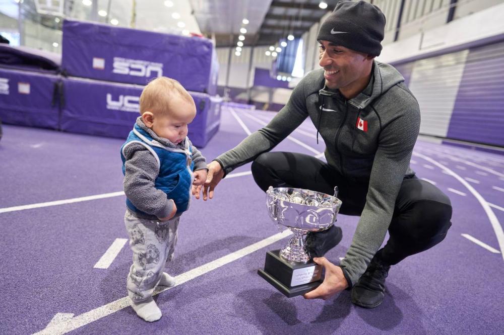 GEOFF ROBINS - Toronto Star
Damian Warner shows his son Theo his Lou Marsh trophy at Thompson Recreation and Athletic Centre at Western University in London, Ont. on Monday.