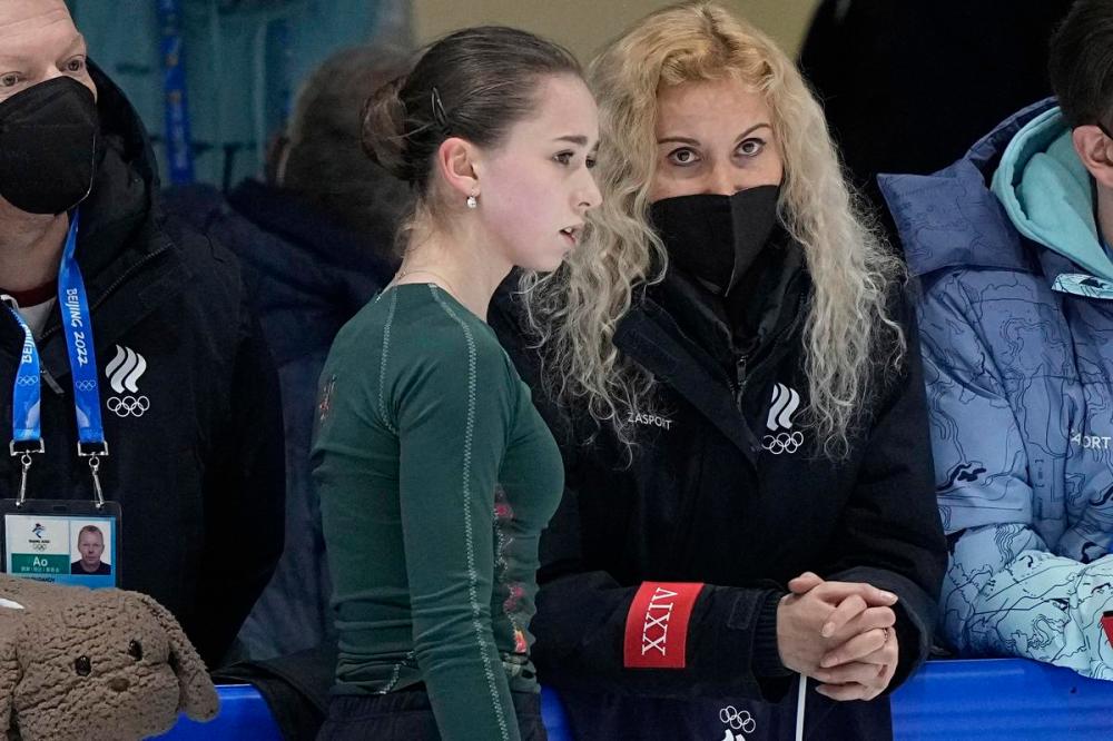 David J. Phillip - AP
Coach Eteri Tutberidze, right, talks to Kamila Valieva, centre, of the Russian Olympic Committee, during a training session at the 2022 Winter Olympics on Sunday.
