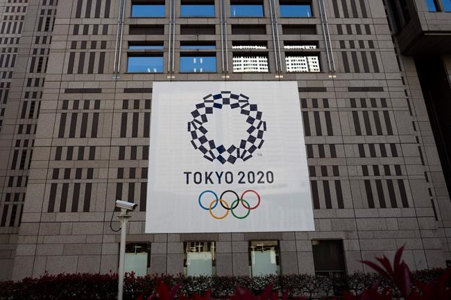A banner promoting the Tokyo 2020 Olympics hands on the facade of the Tokyo Metropolitan Government building Wednesday, March 25, 2020, in Tokyo. Not even the Summer Olympics could withstand the force of the new coronavirus. After weeks of hedging, the IOC took the unprecedented step of postponing the world's biggest sporting event, a global extravaganza that's been cemented into the calendar for more than a century. (AP Photo/Jae C. Hong)