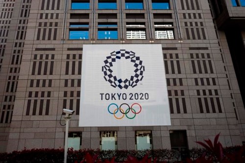 A banner promoting the Tokyo 2020 Olympics hands on the facade of the Tokyo Metropolitan Government building Wednesday, March 25, 2020, in Tokyo. Not even the Summer Olympics could withstand the force of the new coronavirus. After weeks of hedging, the IOC took the unprecedented step of postponing the world's biggest sporting event, a global extravaganza that's been cemented into the calendar for more than a century. (AP Photo/Jae C. Hong)