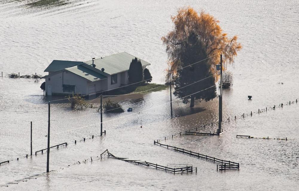 DARRYL DYCK - THE CANADIAN PRESS
A house on a farm is surrounded by floodwaters in Abbotsford, B.C., on Nov. 17, 2021.