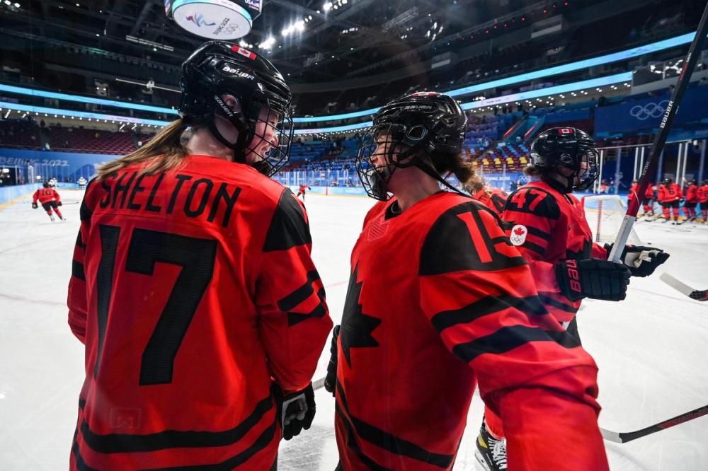 GABRIEL BOUYS - AFP via GETTY IMAGES
Canada’s Ella Shelton and Melodie Daoust warm-up before the women’s gold medal match on February 17, 2022.