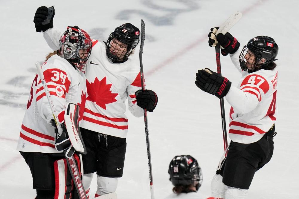 Petr David Josek - AP
Canada goalie Ann-Renee Desbiens celebrates with Emily Clark (26) and Jamie Lee Rattray (47) after a 10-3 win over Switzerland in a women's semifinal hockey game at the 2022 Winter Olympics on Monday