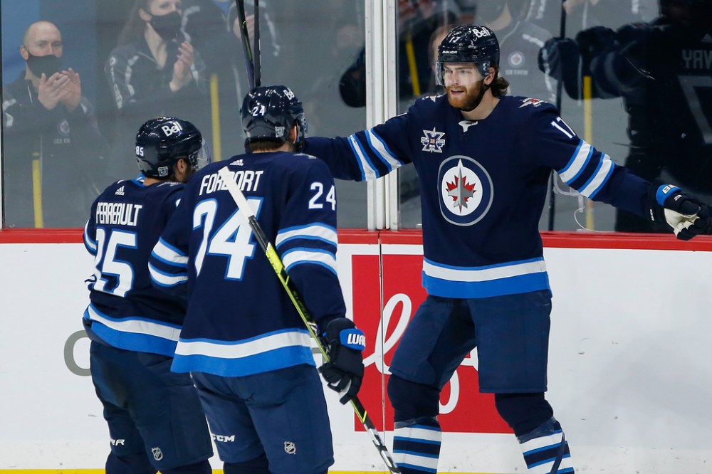 Adam Lowry (right) says the team is getting closer to the identity and the way we want to play: big, fast and imposing. (John Woods / Winnipeg Free Press files)