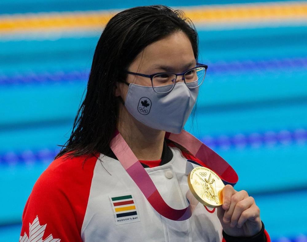 Rick Madonik - Toronto Star
Swimmer Maggie MacNeil waves to the crowd on hand after winning Team Canada’s first gold medal for women's 100m butterfly.
