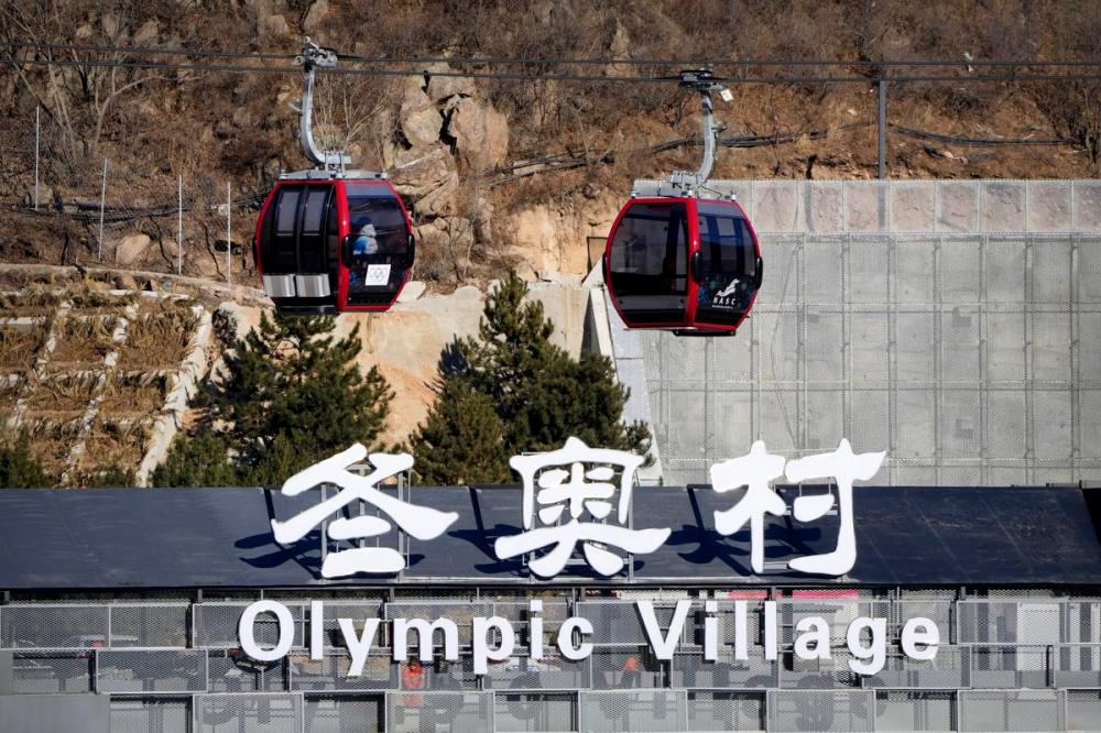 Mark Schiefelbein - AP
Gondolas glide past a sign for the Olympic Village at the 2022 Winter Olympics, Wednesday, Feb. 2, 2022, in the Yanqing district of Beijing.