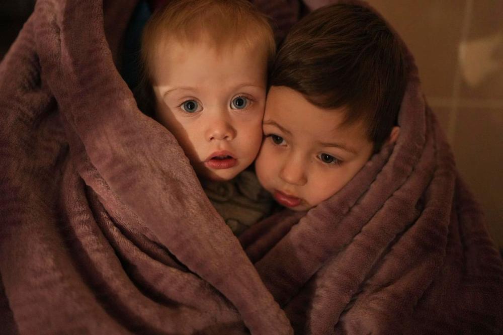 Evgeniy Maloletka - AP
The children of medical workers warm themselves in a blanket as they wait for their relatives in a hospital in Mariupol, Ukraine on March 4.