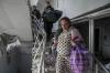 Evgeniy Maloletka - AP
An injured pregnant woman walks downstairs at a maternity hospital shelled by Russian forces in Mariupol, Ukraine on March 9, 2022.