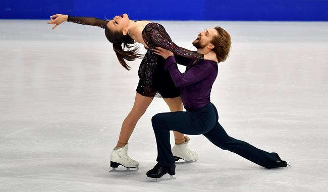 Kaitlin Hawayek and Jean-Luc Baker of the USA perform during the Ice Dance - Rhythm Dance at the Figure Skating World Championships in Stockholm, Sweden, Friday, March 26, 2021. (AP Photo/Martin Meissner)