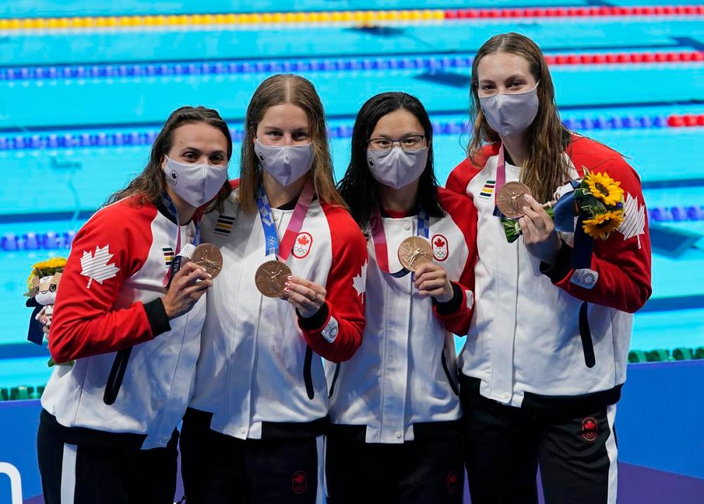 Adrian Wyld - THE CANADIAN PRESS FILE PHOTO
From left, Canada's Kylie Masse, Sydney Pickrem, Maggie Mac Neil and Penny Oleksiak celebrate a bronze medal in the women's 4x100 medley relay final during the Tokyo Summer Olympic Games on Aug.1.