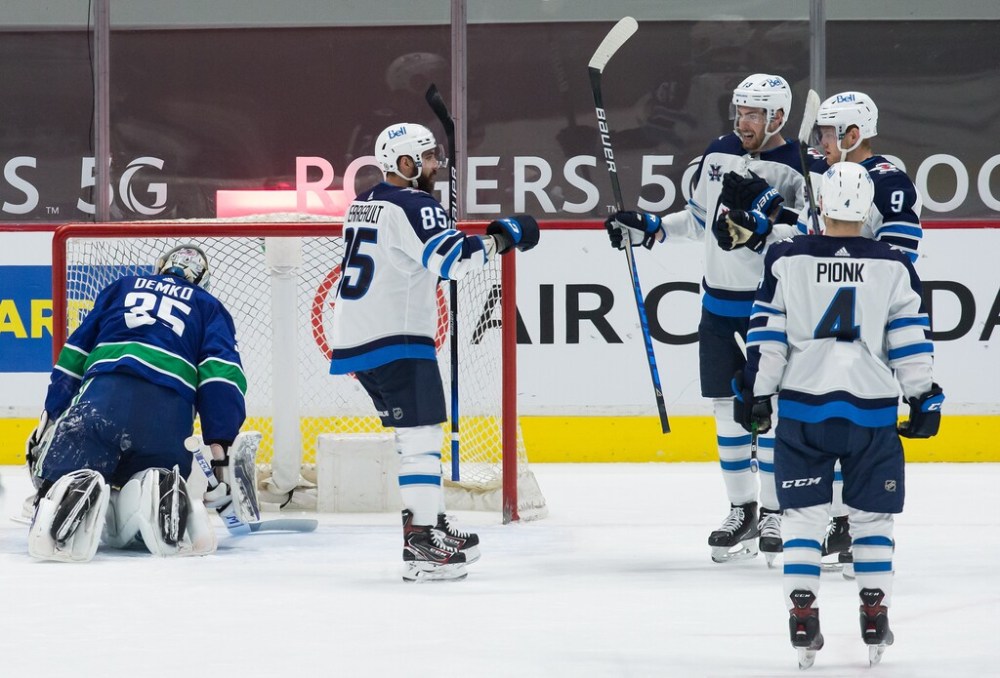 CP
Mathieu Perreault, Pierre-Luc Dubois, Andrew Copp and Neal Pionk celebrate Copp's second goal against Vancouver on Wednesday. (Darryl Dyck / The Canadian Press)