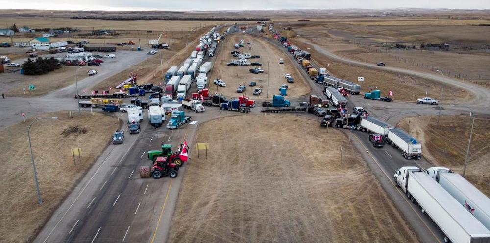 Jeff McIntosh - The Canadian Press
Anti-vaccine mandate demonstrators gather as a truck convoy blocks the highway the busy U.S. border crossing in Coutts, Alta on Jan. 31, 2022.