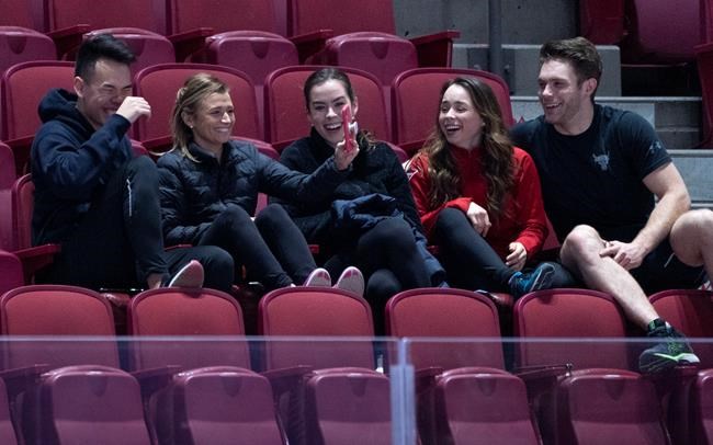 Canadian figure skaters Nam Nguyen, Kirsten Moore-Towers, Alicia Pineault, Evelyn Walsh and Trennt Michaud, left to right, ham it up prior to hitting the ice for a practice in Montreal, on Monday, February 24, 2020. Upcoming world championships in Canadian cities have so far avoided cancellation, but the new coronavirus is laying waste to other championships around the world and impacting Canadian athletes. THE CANADIAN PRESS/Paul Chiasson