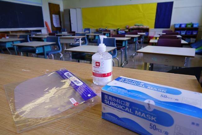 Personal protection equipment is seen on the teacher's desk in classroom in preparation for the new school year at the Willingdon Elementary School in Montreal, on Wednesday, August 26, 2020. THE CANADIAN PRESS/Paul Chiasson