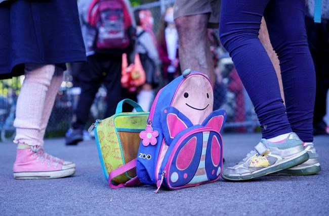 A school bag and a lunch bag are seen in the school yard at the Bancroft Elementary School as students go back to school in Montreal, on Monday, August 31, 2020. THE CANADIAN PRESS/Paul Chiasson