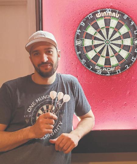 Using a United Kingdom-based site that allows users to play darts against each other via webcam, Sean Kluczkowski has played people from all around the world. (Supplied)