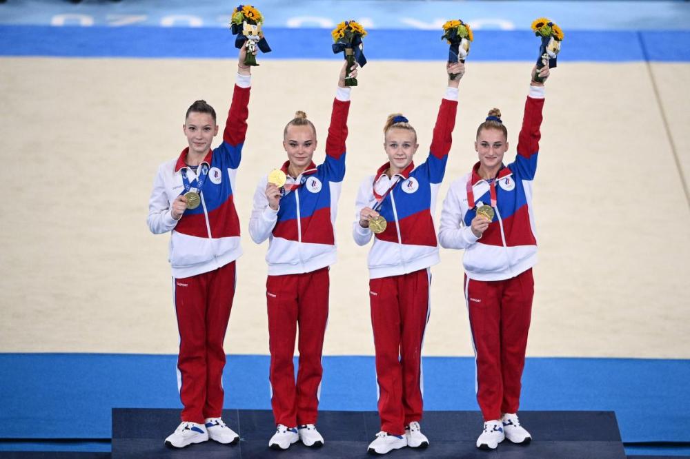 MARTIN BUREAU - AFP via GETTY IMAGES
Gold medalists Russia's Liliia Akhaimova, Russia's Angelina Melnikova Russia's Viktoriia Listunova and Russia's Vladislava Urazova celebrate on the podium after winning the artistic gymnastics women's team final.