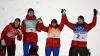 CHRISTOF STACHE - AFP via GETTY IMAGES
Canada's Alexandria Loutitt, Canada's Matthew Soukup, Canada's Abigail Strate and Canada's Mackenzie Boyd-Clowes celebrate their third place finish on the podium following the Ski Jumping Mixed Team Final, on February 07, 2022 at the Zhangjiakou National Ski Jumping Centre.