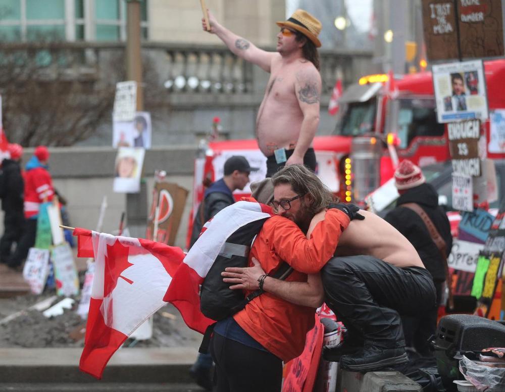Steve Russell - Toronto Star
Shirtless protesters get hugs at one of the barricades in Ottawa on Feb. 17, 2022 after local police handed out papers warning them to leave or face arrest.