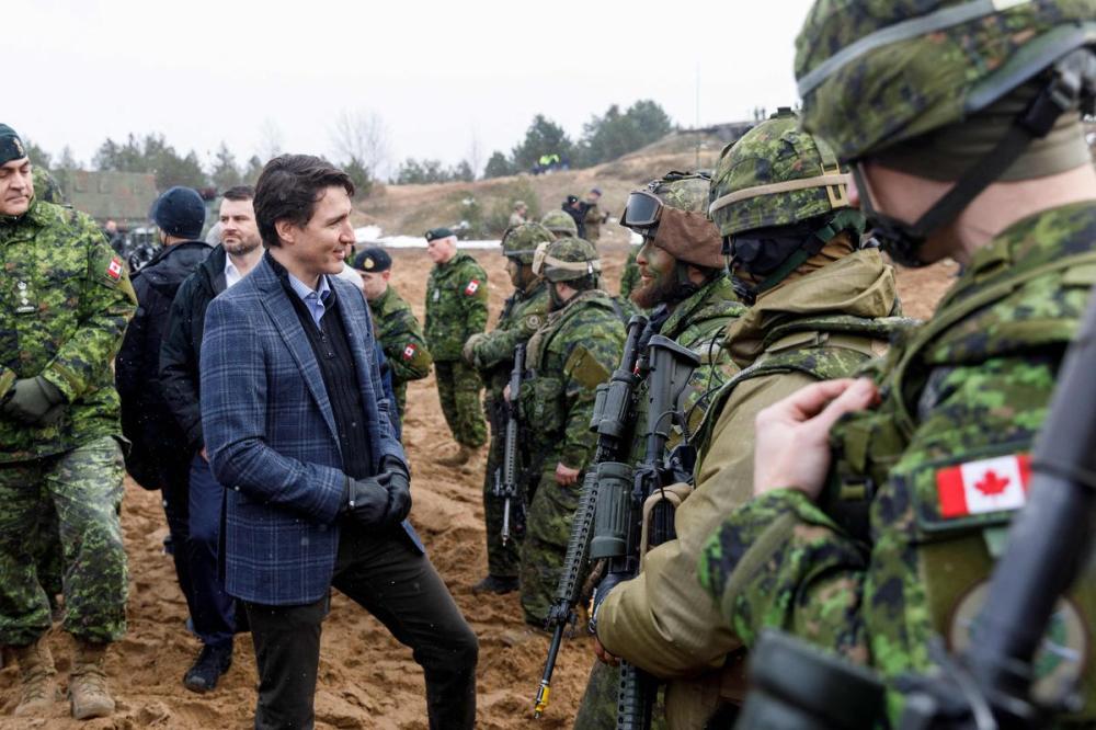 TOMS NORDE - AFP via GETTY IMAGES
Prime Minister Justin Trudeau talks with soldiers during a visit at the Adazi military base, north east of Riga, Latvia, on March 8, 2022.
