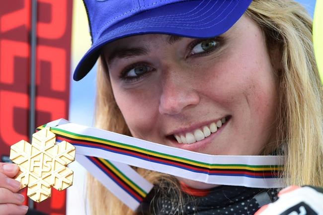 United States' Mikaela Shiffrin shows her gold medal for the women's combined race, at the alpine ski World Championships, in Cortina d'Ampezzo, Italy, Monday, Feb. 15, 2021. (AP Photo/Marco Tacca)