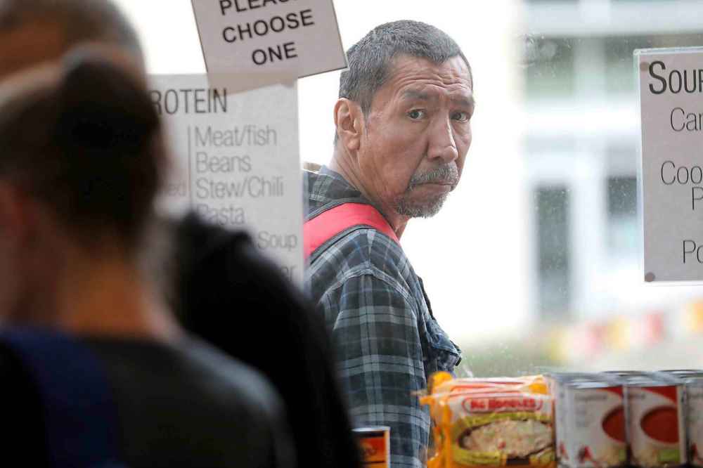 A customer looks into the store window to see what is available this week.