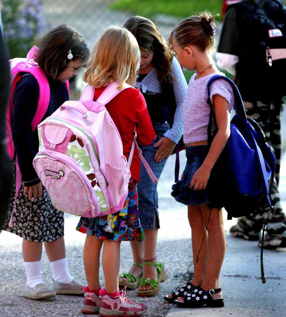Grade 1: Shelby, (from left) Hailey, Paige and Abygale check out their back to school outfits on their first day of school. (Wayne Glowacki / Winnipeg Free Press)
