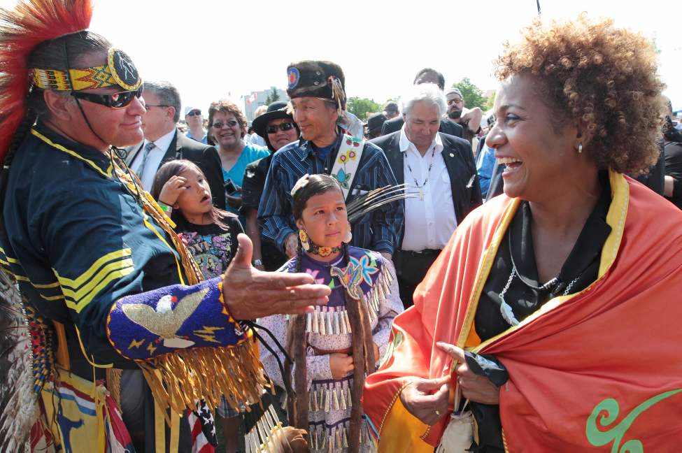 JOE BRYKSA/WINNIPEG FREE PRESS
Gov. Gen. Michaelle Jean , right, laughs as Lance Sandy, a residential school survivor from North-West Angle, Ontario, trys to get a handshake as she leaves a pow wow event at the Truth and Reconciliation Commission's final day of ceremonies at the Forks. June 19, 2010.