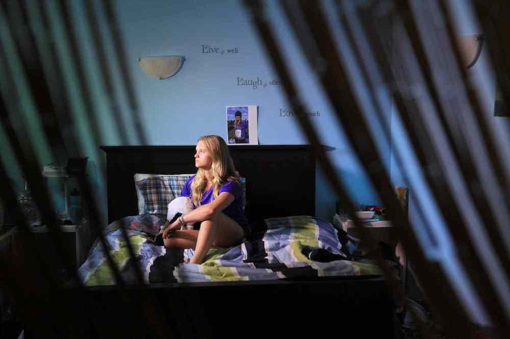 Grade 11: Naomi holds a picture of herself taking part in a Mental Health Run for women. She talks openly about her own challenges dealing with mental health issues and hopes her candor will bring more awareness and support to young people dealing with similar mental health issues. (Ruth Bonneville / Winnipeg Free Press)
