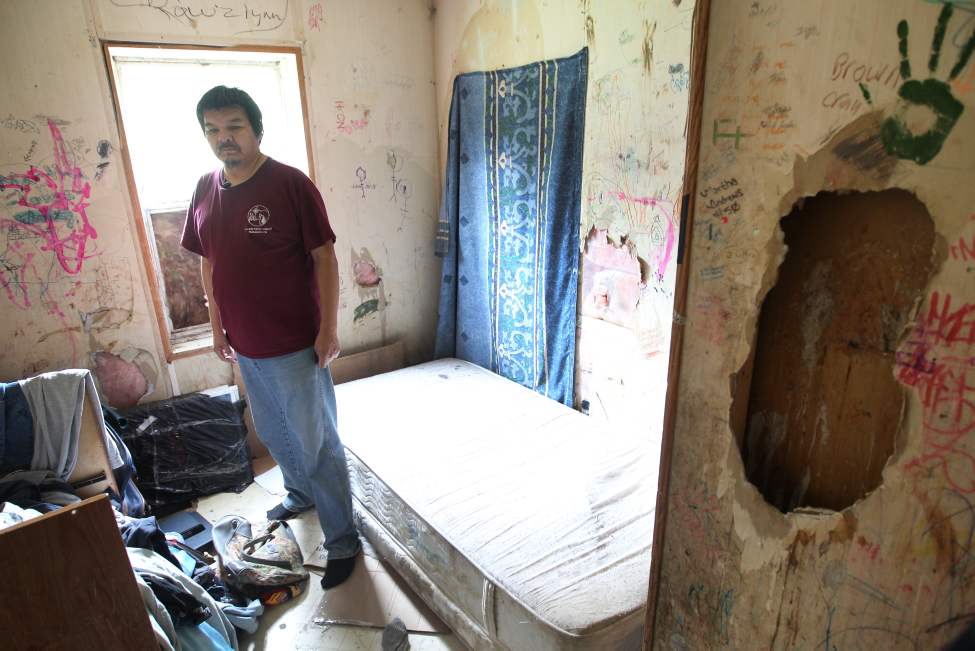 Standing in the gloom of his sagging trailer, he surveys the muddy floor, the goopy flypaper dangling from the kitchen ceiling, the piles of dirty clothes and the dishes stacked in a sink with no faucet. Graffiti and children's scribbles cover what remains of the walls, around holes that allow pink insulation to peek out. It's freezing in the winter, mouldy when the furnace kicks in and worse than even the slummiest apartment in Winnipeg.