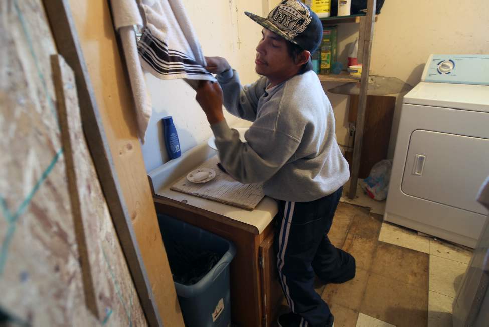 Kevin Taylor struggles to dry his hands. His mother Alice has filed a human rights complaint to provide him with proper services on the reserve. 
(JOE BRYKSA / WINNIPEG FREE PRESS)