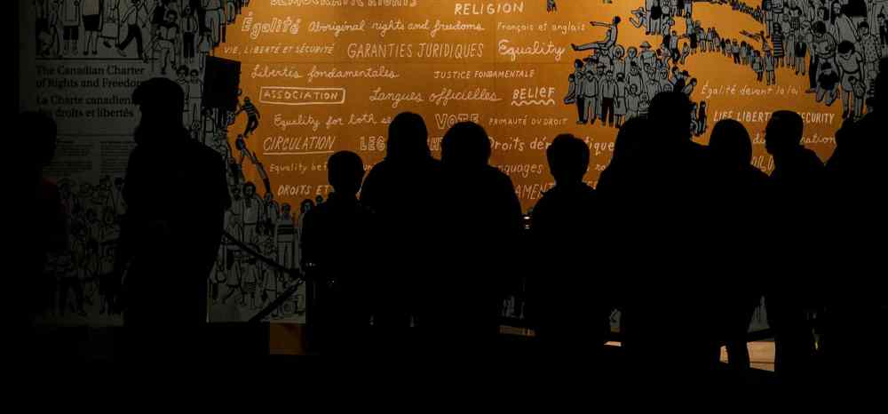 Melissa Tait / Winnipeg Free Press
A group of visitors in front of a display on the Canadian Charter of Rights and Freedoms in the Protecting Rights gallery at the Canadian Museum for Human Rights on Saturday. Thousands had reserved tickets for the four gallery preview tour on Saturday and Sunday. That is only four of 11 galleries, the rest of which open Sept. 27.