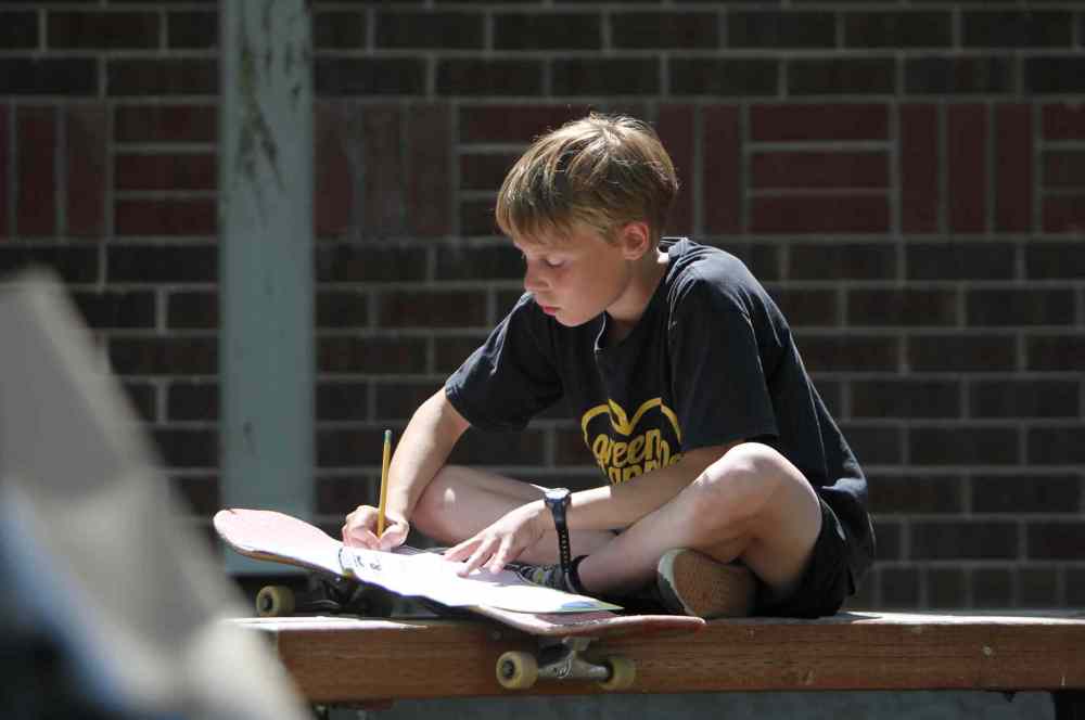 Julius, in grade 6, works on his writing skills.