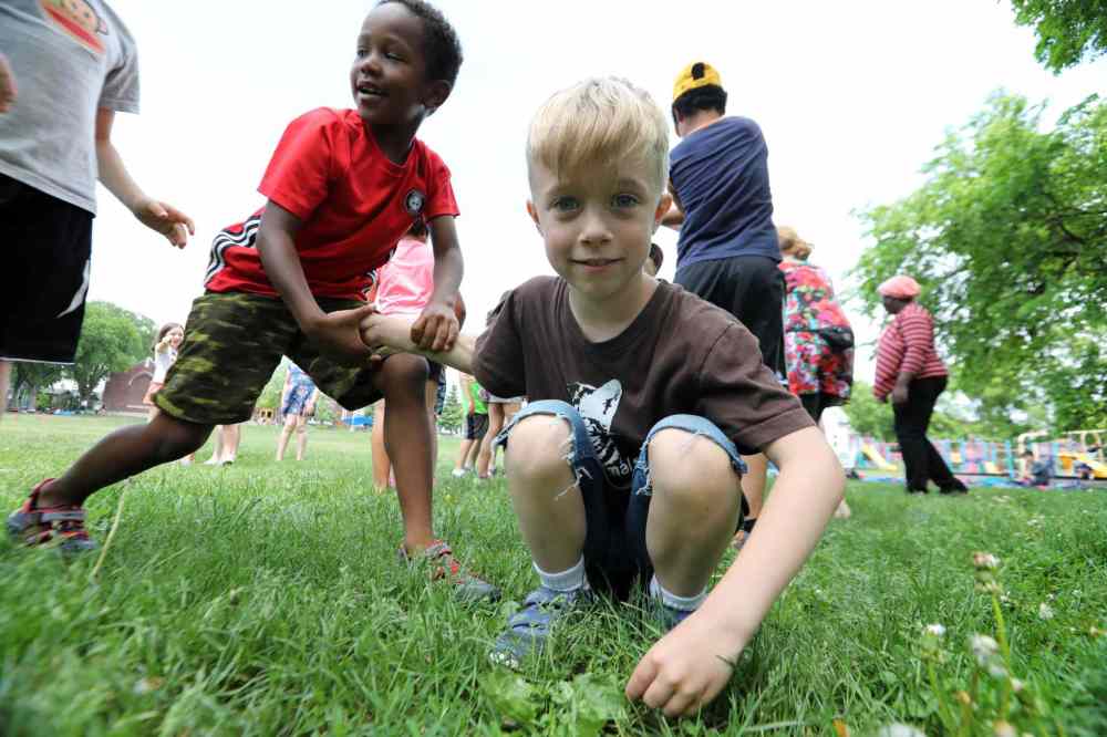 First graders Chikondi (left) and Wellington take part in free play dance class.