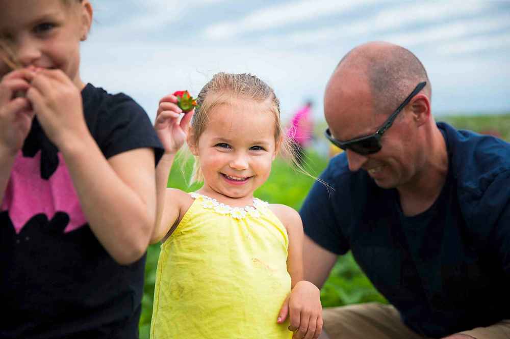 Prestley Bjornson, two, shows off a strawberry.