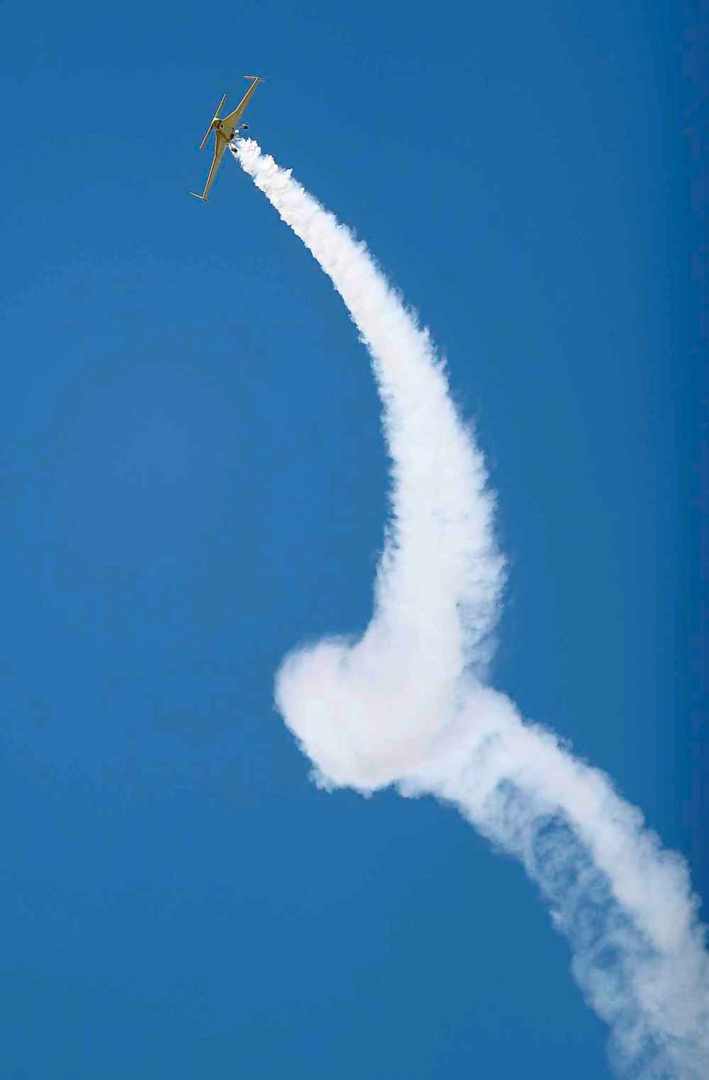 Kyle Fowler's plane leaves a condensation trail in its wake.