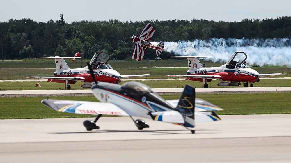 A pilot takes his plane near the Snowbirds.