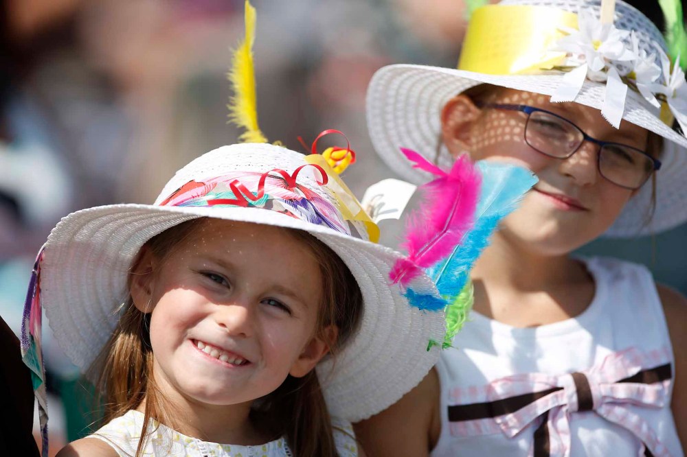 Annika, 5, and Nora Hansen, 7, wearing fancy hats.