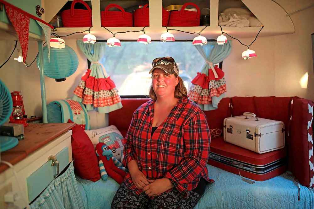 Sam McKay of Vancouver Island, part of a caravan of Boler enthusiasts headed to Winnipeg, sits inside her decorated Boler camper near Brandon Tuesday evening. (Tim Smith/The Brandon Sun)